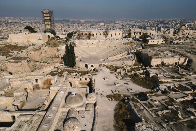 This aerial view shows the Citadel overlooking the city of Aleppo on December 17, 2024. - Aleppoís Old City, a UNESCO World Heritage Site since 1986, was devastated during the conflict that began in 2011, with intense battles between Syrian forces and rebels from 2012 to 2016, leaving its population of 2.1 million nearly emptied after a brutal siege. Now, after Assad's fall following a lightning rebel offensive led by Islamist group Hayat Tahrir al-Sham, residents are looking forward to reconstruction. (Photo by Ozan KOSE / AFP) / TO GO WITH 'SYRIA-CONFLICT-HISTORY-HERITAGE'