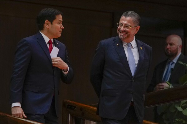 Secretary of State Marco Rubio, left, and Costa Rican President Rodrigo Chaves arrive to give a joint news conference at the presidential palace in San Jose, Costa Rica, Tuesday, Feb. 4, 2025. (AP Photo/Mark Schiefelbein, Pool)