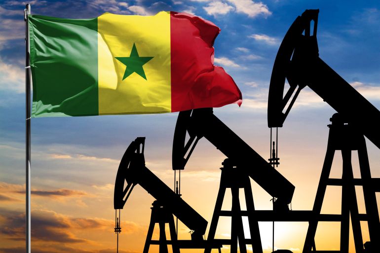 oil rigs against the backdrop of the colorful sky and a flagpole with the flag of senegal. the concept of oil production, minerals, development of new deposits.; shutterstock id 1919552321; purchase_order: aljazeera ; job: ; client: ; other: