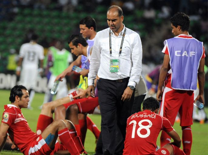 tunisian coach sami trabelsi (c) comforts his players after being defeated by mali at the end of the africa cup of nations (can) quarter-final football match ghana vs tunisia at franceville stadium in gabon on february 5, 2012. ghana won 2-1 and reach the semi-final